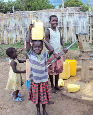 Girls collect water from a well in the Anglican compound in Torit Dioceses, Eastern Equatoria, South Sudan. © ABM/Julianne Stewart 2012.