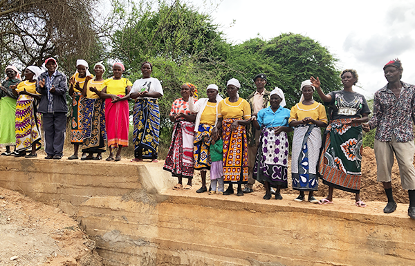 Members of the Kwa Usingi Sand Dam Committee proudly stand on their completed dam wall in Makueni County, Kenya. The dam was built by the community, supported by ABM’s Kenyan partner, Anglican Development Services, Eastern, using funding from Australian Aid. 