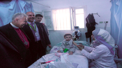 Bishop Suheil Dawani visiting a patient at the hospital. © Episcopal Diocese of Jerusalem 2015