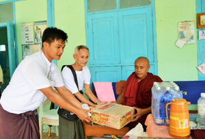 Giving relief aid donation to a monk.