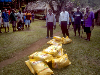 Isuk community receiving their relief supplies from ACOM Disaster Relief team. © ACOM 2015