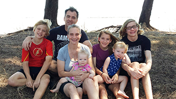 Ben Van Gelderen and family pictured with Nungalinya Rock in the background. © Nungalinya College.