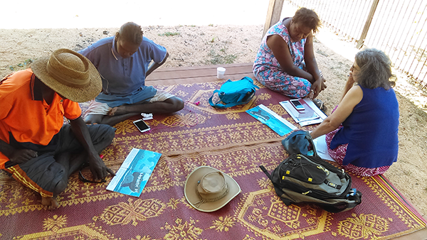 Christians on Bickerton Island reading the Bible Society story books which have had Anindilyakwa text added alongside the English. © Diocese of the Northern Territory.