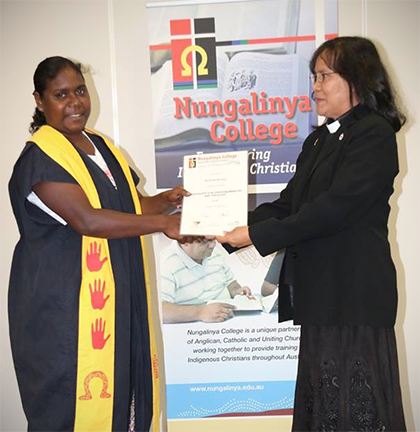 Kylinda Brown receiving her graduation certificate