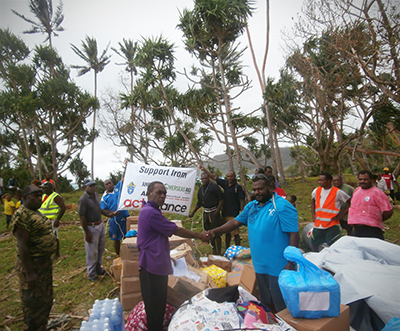 Formerly handing supplies frm Bishop Worek to NDMO's Coordinator Philip Meto at Loh