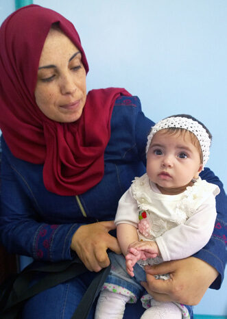 Mother and child participating in the Child Nutrition Program. Staff at Al Ahli Hospital are able to supply vitamins and nutrition advice to participating families. © ABM, Julianne Stewart 2017.