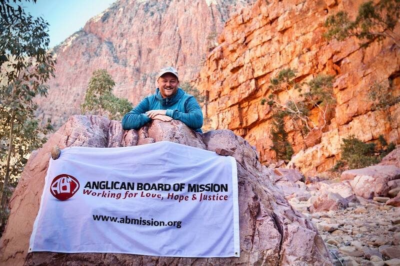 Rev’d Michael poses with the ABM banner at Ormiston Gorge.