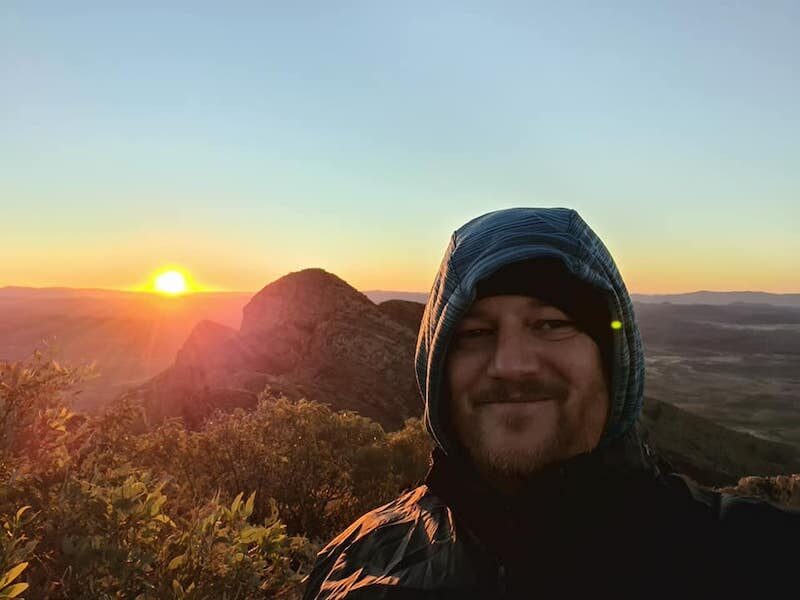 Rev’d Michael at the summit of Rwetyeome at sunrise.