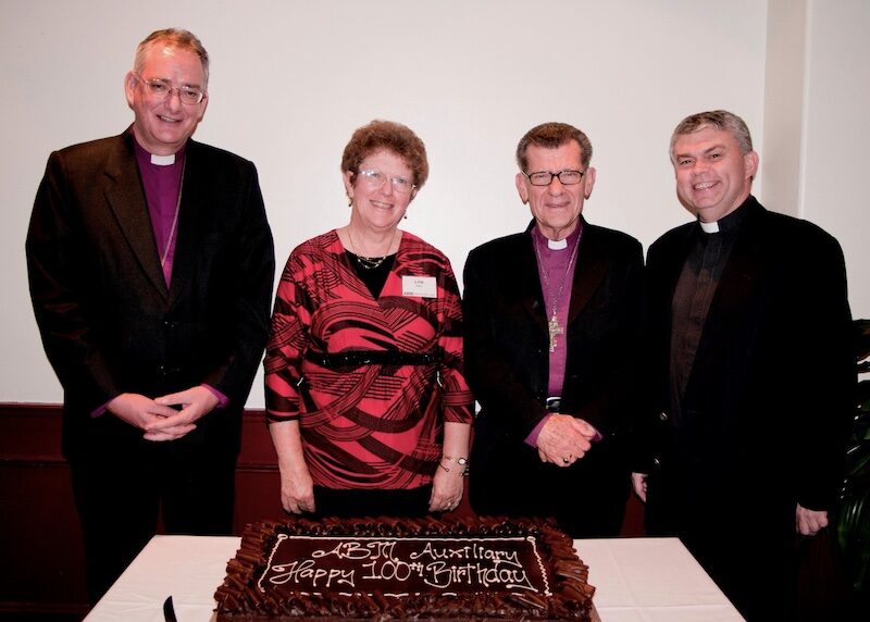 ABM Auxiliary 100th Birthday Lunch July 2010. L to R Archbishop Philip Aspinal, Mrs Lyn Hall, Bishop David McCall and the Rev’d Dr John Deane. © Moya Holle. Used with permission.
