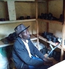 Amos with his small shoe-shine business before receiving assistance from the program . © Diocese of Eldoret Community-Based Rehabilitation Centre, 2018, used with permission .
