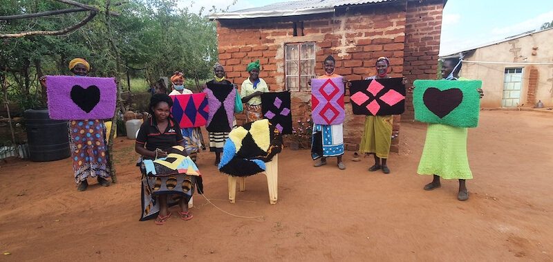 Members of the Umiisyo Wa Iiani self-group show off their newly-made mats. © ADSE. Used with permission.