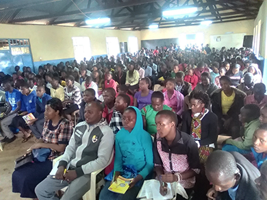 Youth and children listening intently during the conference
