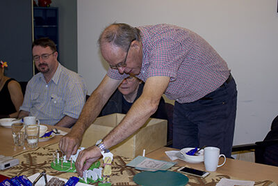 Fr John Corner showing ABM staff how the CGS materials are used in class.