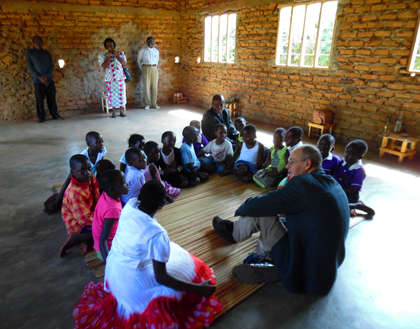 John Corner sitting with CGS children