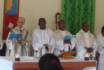 Fr Denny Guka (centre) with Bishop Peter Ramsden (far left). © ABM/Meagan Schwarz 2014