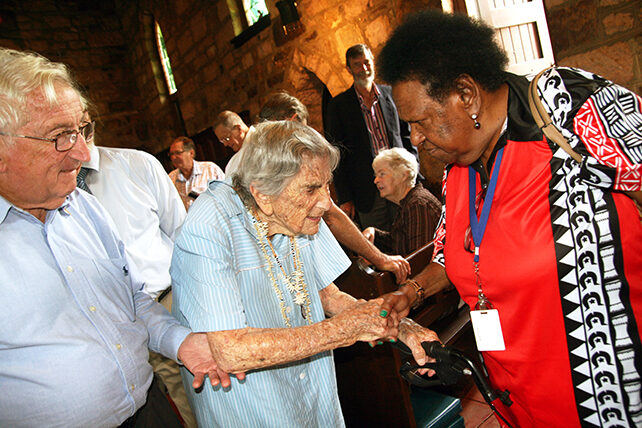 Sr Helen Barrett being congratulated by Rose Elu, a member of the National Aboriginal and Torres Strait Islander Anglican Council, after receiving the ABM Coaldrake Award. © Sarah Gover/ABM 2017.