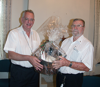 Archbishop Phillip presents a gift to Rev Ken Spreadborough.