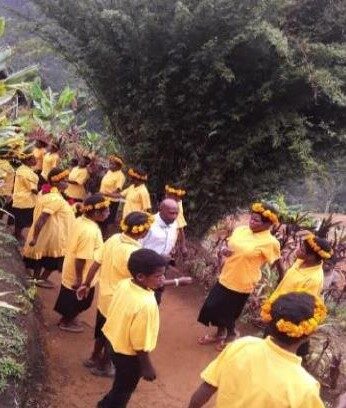 Graduates in yellow shirts and garlands welcomed the visitors