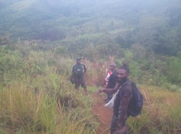  The visitors (Morrison is in the middle of the three walkers) left at three in the morning to walk into the village