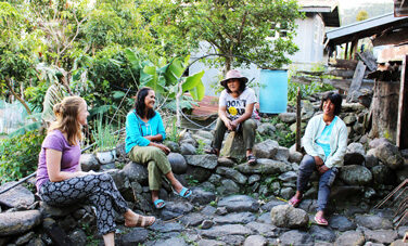 Kate Winney (left) talking with group members who participate in the pig raising project in Angkeling. © ABM, Sarah Gover 2017.