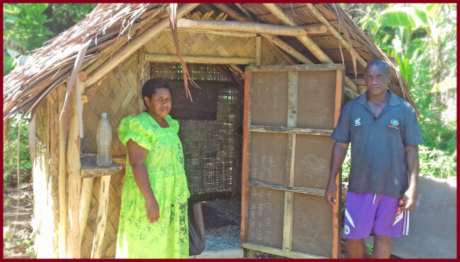 ACOM Vanuatu’s Project Officer, Rucinta Vora with Rainol Qenegle, and the toilet that has been built near the church