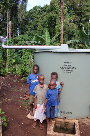 Children in St Peter's Parish with their new water tank.