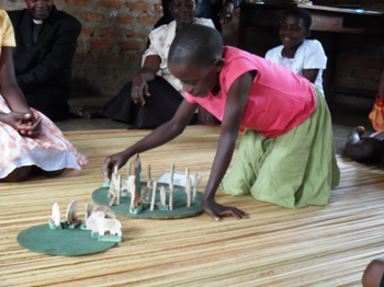 Children working with the Good Shepherd material at Namatala slum, Uganda.