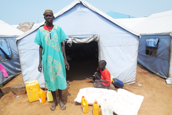 A woman with her relief supplies. © ECSSS 2014