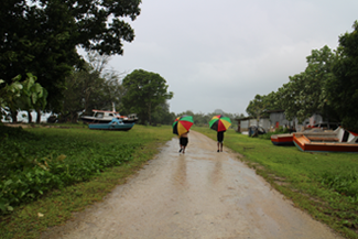 Locals battle the rains in Sola. ©ABM/Jess Sexton 2015