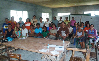 Lina, on right in blue top and glasses, at a community meeting in Aklan Province. © ABM 2016.