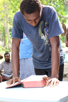 A literacy student reads the Bible. ©ABM/Jess Sexton 2015