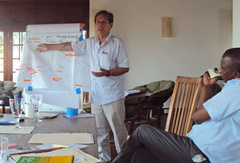 San Lin from the Church in the Province of Myanmar role plays a disaster risk mapping exercise for use with communities.