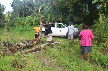 ACOM staff clearing a road. © ABM/Jess Sexton 2015