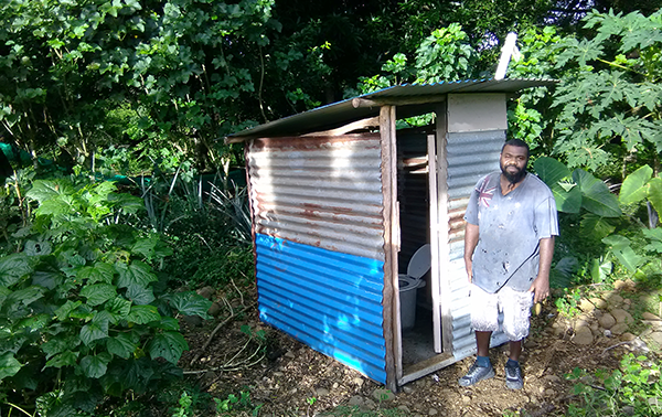 Milton and the toilet he built for his uncle in Narevorovo, Maewo Island, Vanuatu.