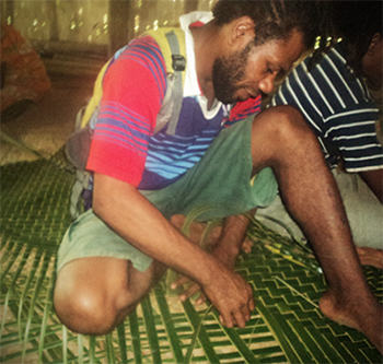 Ray  Rayman makes a palm leaf mat for his Literacy class. © Kate Winney/ABM 2016.