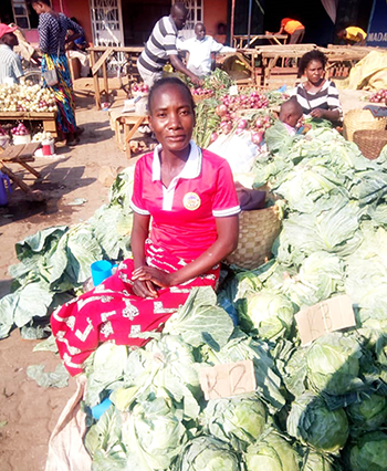 Catherine with her cabbages for sale at the market.